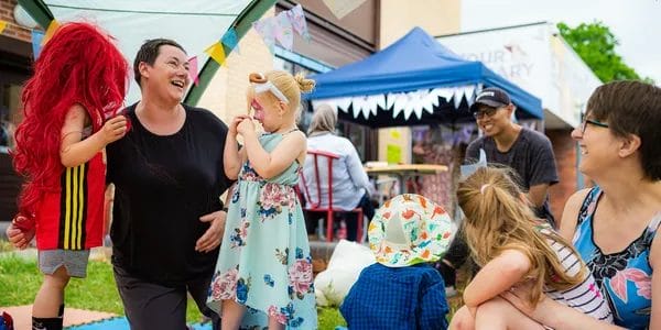 One of the contributors is engaged in a workshop with the children