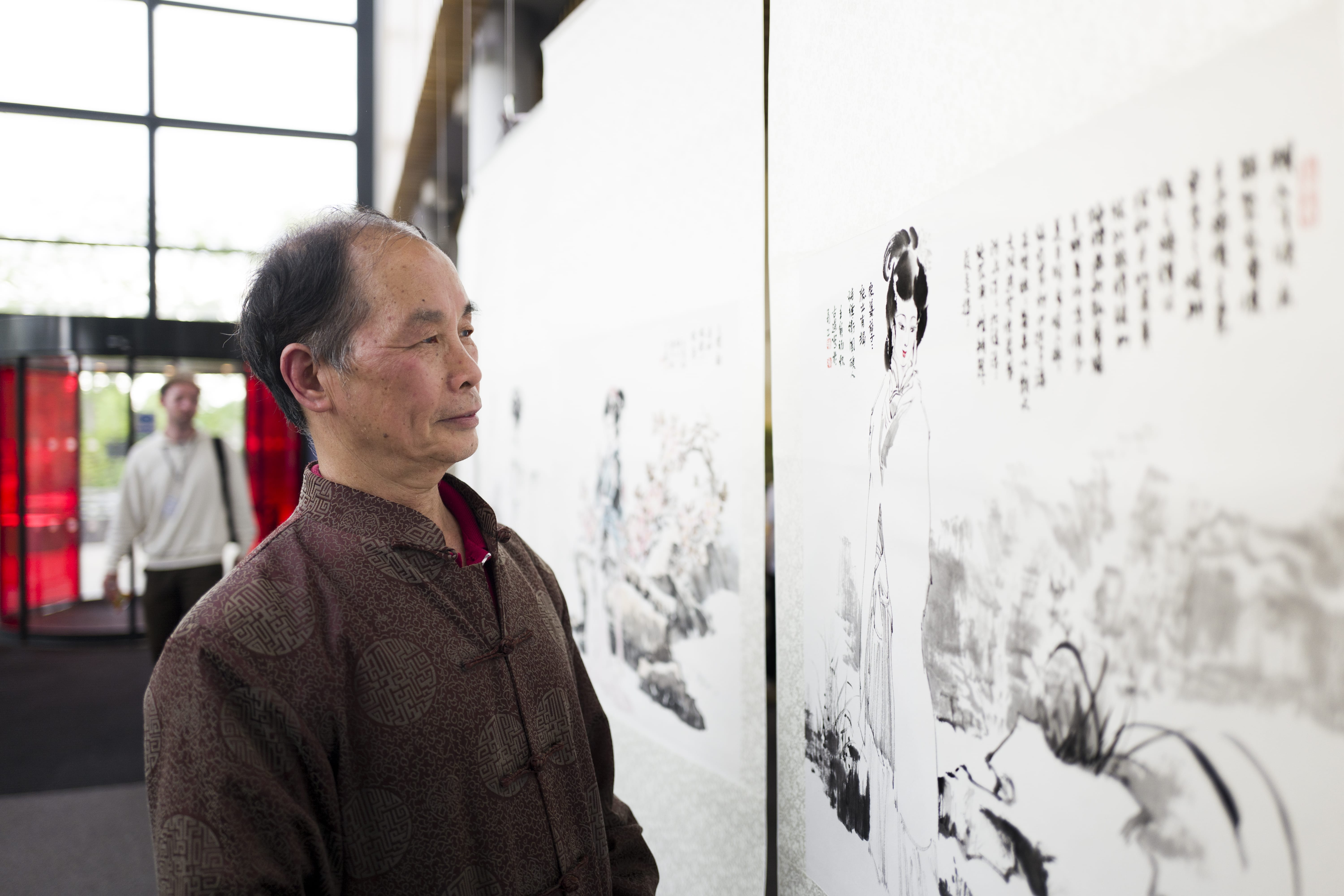 Chinese artist Li Qingyu looks on at his artwork