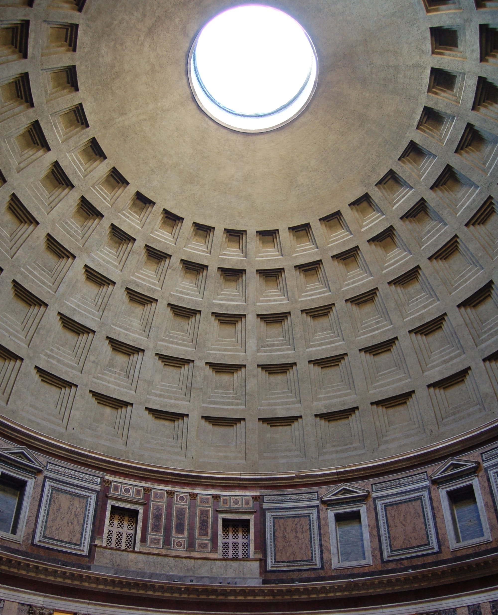 Interior of the Pantheon, Rome. A light shines through a window at the top of the dome.