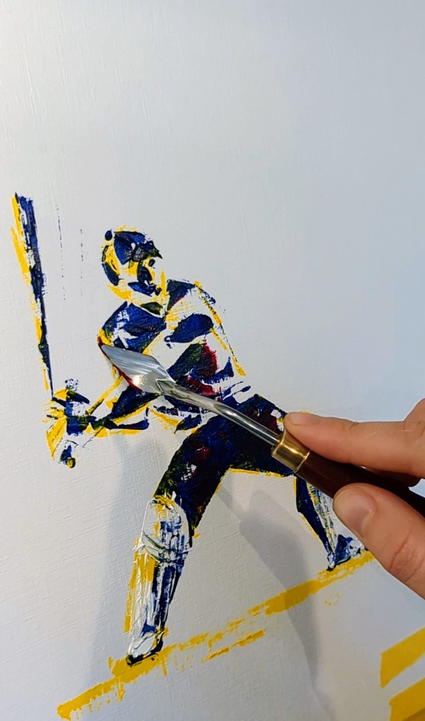 An oil painting of a figure playing cricket, with a hand adding paint to the piece.